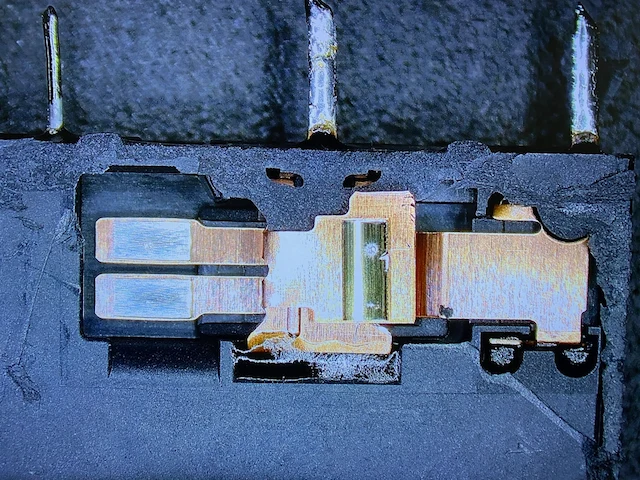 Cross-section of a relay after test cycles with a discolored contact assembly